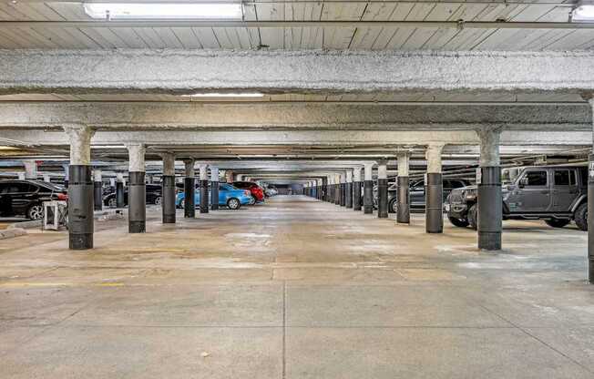 an empty parking garage with cars parked in it