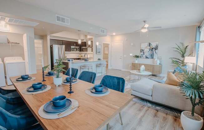 A modern dining room with a wooden table set for a meal.