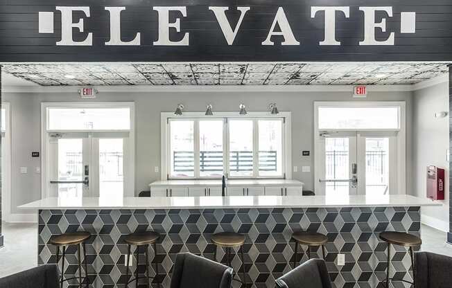 a view of the lobby of a restaurant with a bar and stools