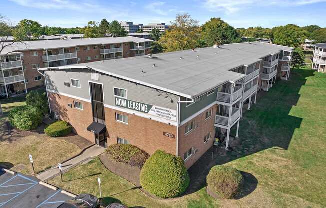 an aerial view of an apartment building with a solar panel roof