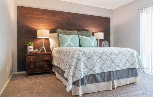 a bedroom with a bed and a wooden headboard