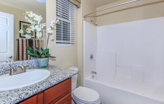 a large white tub next to a sink