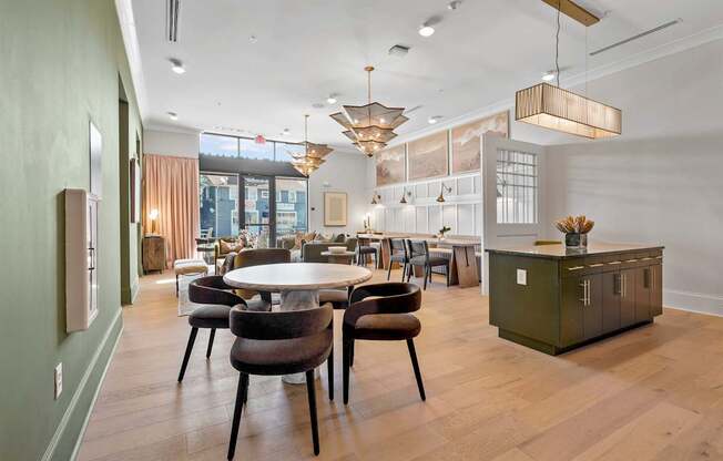 A modern dining room with a round table and chairs.