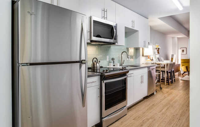 Studio Kitchen with Stainless Steel Appliances and Quartz Countertops. Furnishings by Room & Board