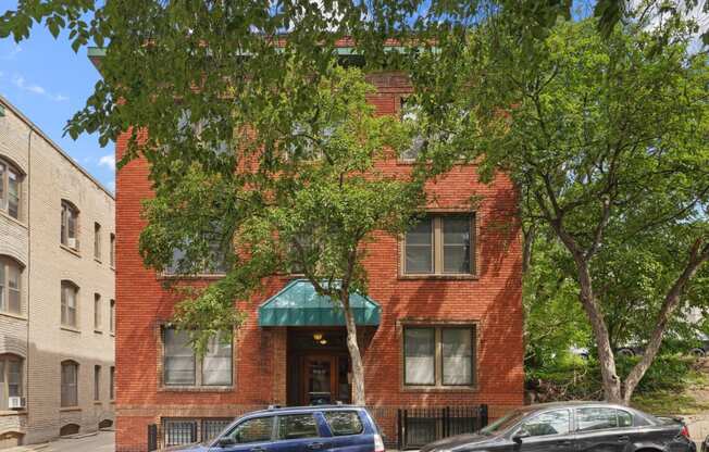 a red brick building with a green awning