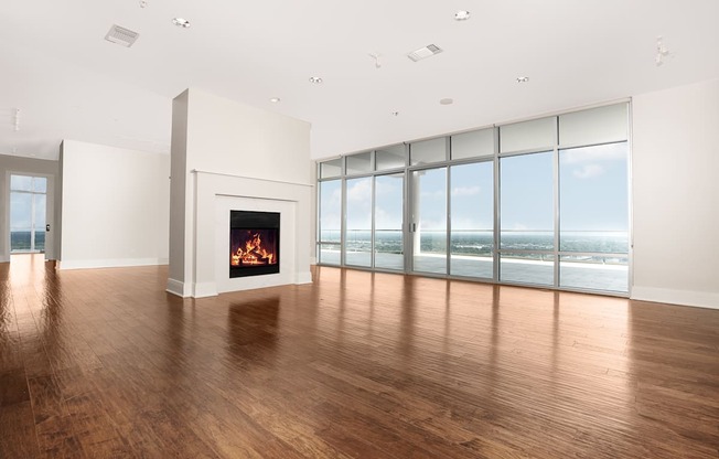 Luxury Apartments Northeast Dallas, TX - Heights at Park Lane - Living Room with Fireplace, Large Windows, and Hardwood Floors.