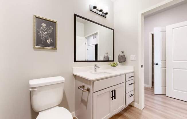 A bathroom with a white toilet and a white sink.