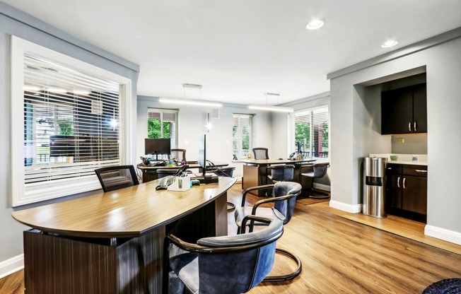 a living room with a table and chairs and a kitchen