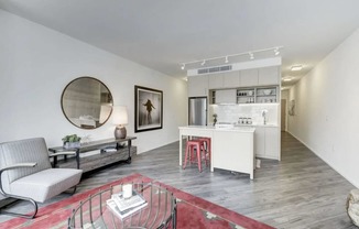 a living room with a couch and a table and a kitchen