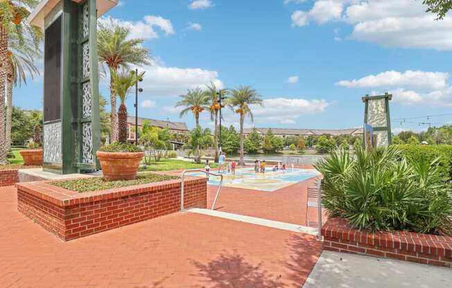 a swimming pool with palm trees and a building in the background