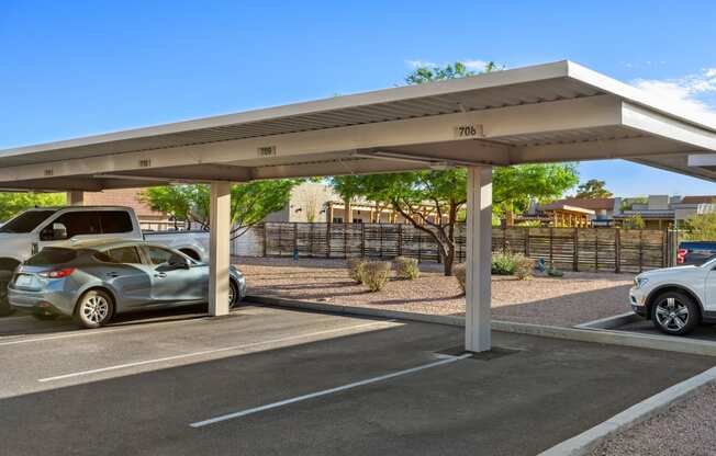 a carport in a parking lot with cars in the parking lot
