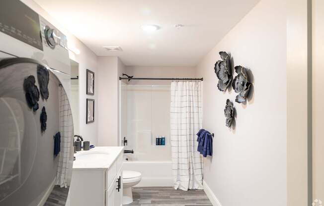 A bathroom with a white sink and a white toilet.