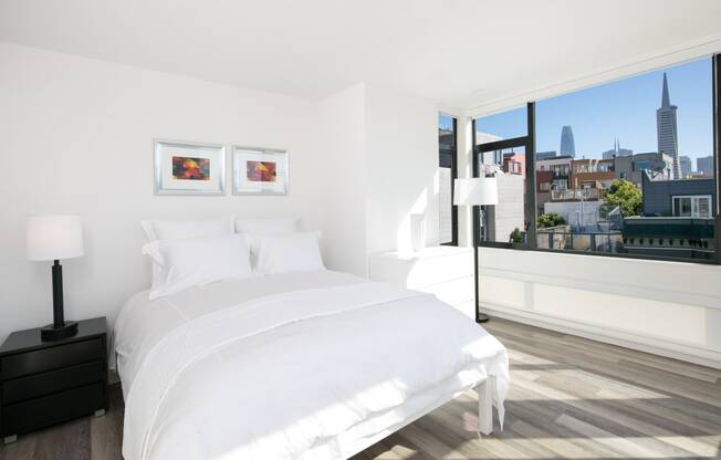 a bedroom with a large bed and a large window