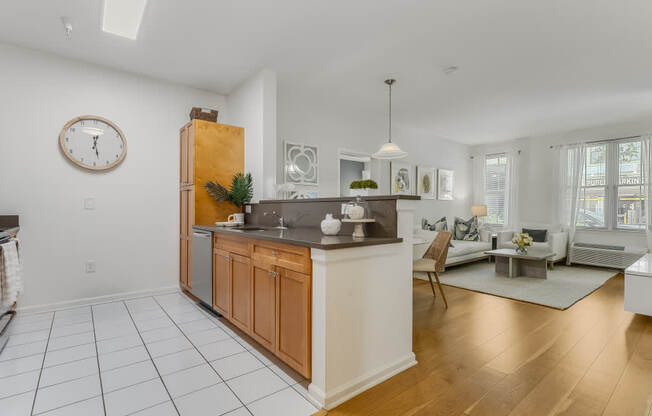 A kitchen with a wooden island and a clock on the wall.