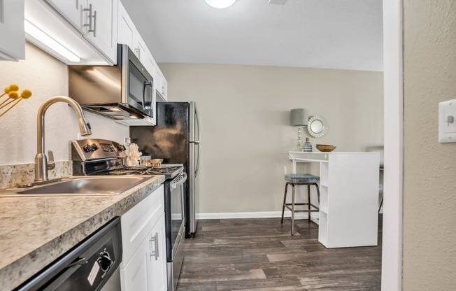 a kitchen with white cabinetry and stainless steel appliances