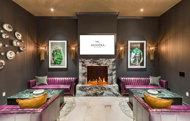Cozy up by the fireplace in a stylish lounge designed for both comfort and connection at Modera Argyle.