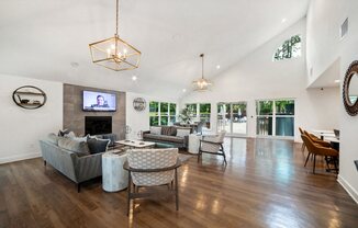 a living room with couches and chairs and a fireplace at Chapel View Apartments in Chapel Hill, NC