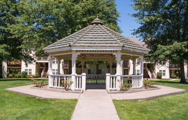 a gazebo in a yard in front of a house