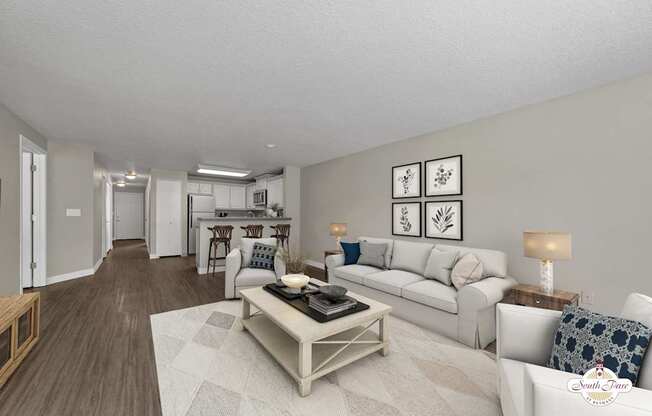 A living room with a white couch and a coffee table.