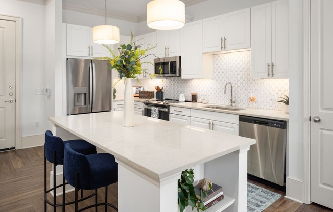 a large white kitchen with a white counter top