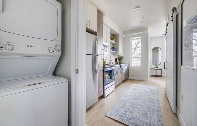 In-unit washer and dryer next to a kitchen area