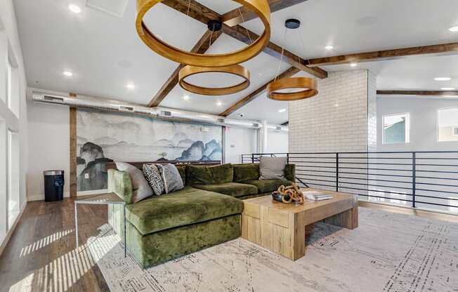 A living room with a green couch and a wooden coffee table.
