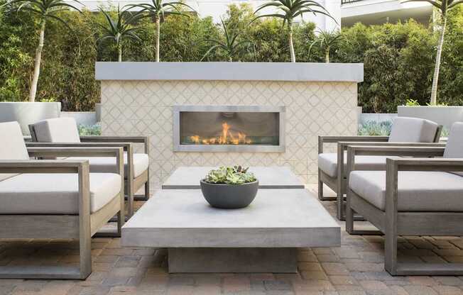 A fireplace with a bowl of flowers in front of it.