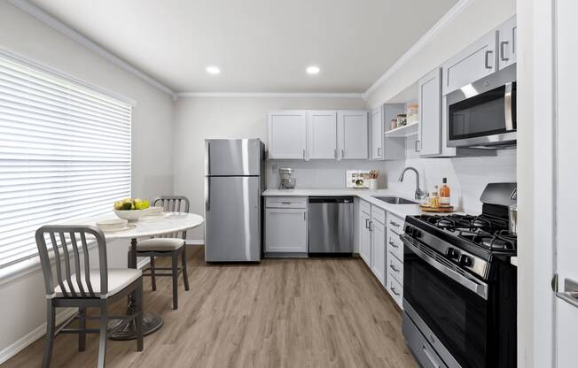 a kitchen with white cabinetry and stainless steel appliances  at Sunset Heights, San Antonio, TX, 78209