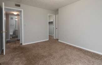 A room with carpeted floor and white walls.