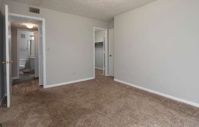 A room with carpeted floor and white walls.