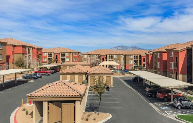 an empty parking lot in front of a row of town houses