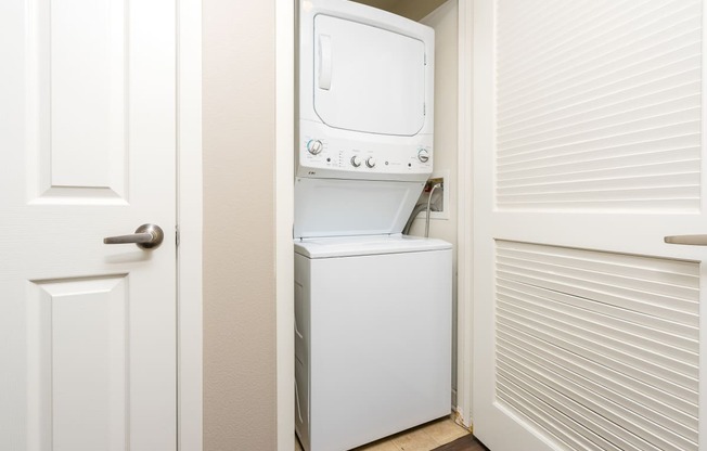 a washer and dryer in a small laundry room