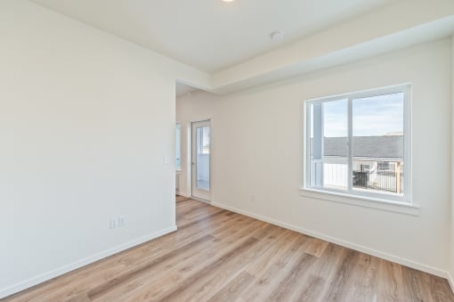 a living room with white walls and a window at Gateway Apartments, East Wenatchee , Washington