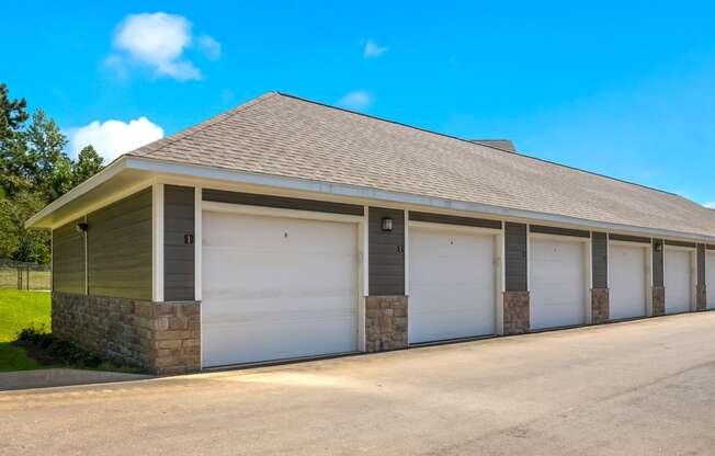 a row of garages with a blue sky in the background