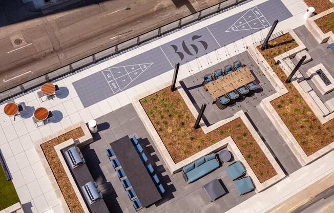 A top view of a parking lot with a number 365 painted on the ground.