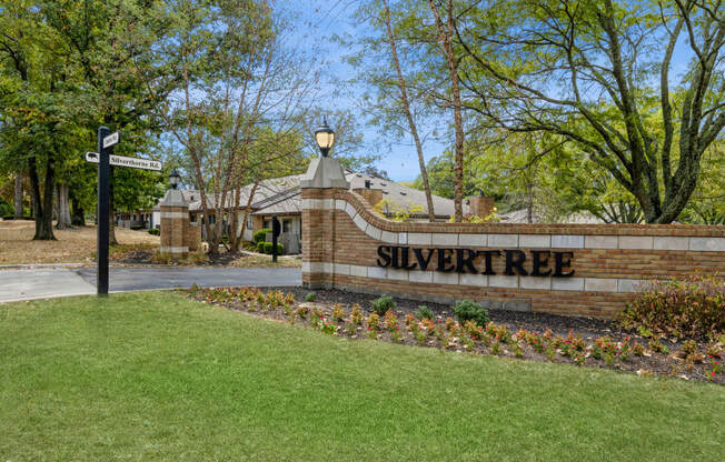 the entrance to the silver tree neighborhood sign in front of a building