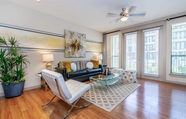 a living room filled with furniture and a large window