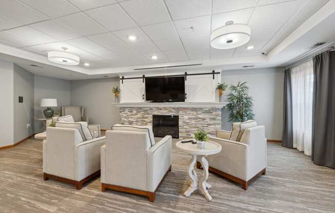 the living room of our apartments atrium with couches and a fireplace