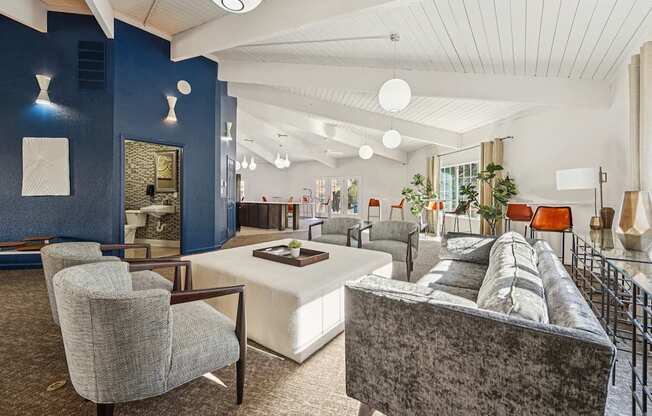 A living room with a grey couch and a white coffee table.