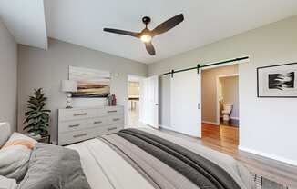 a bedroom with a bed and a ceiling fan