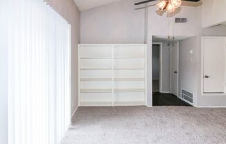 a room with white walls and white furniture and a white door