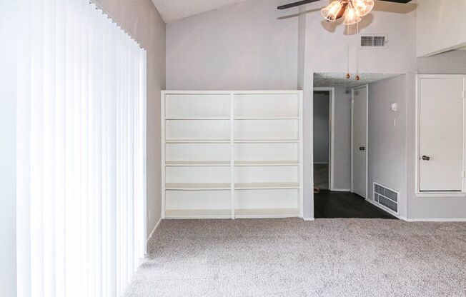 a room with white walls and white furniture and a white door