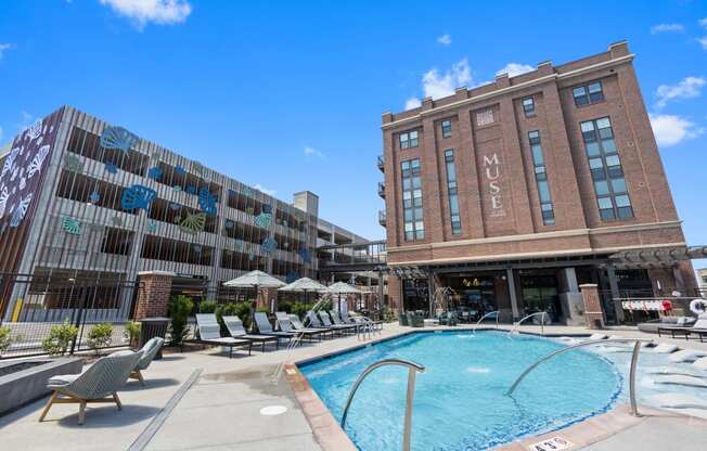 a swimming pool in front of a brick building