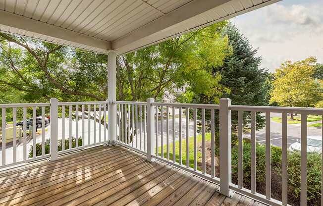 Orchards Apartments Marlborough ma apartment loft style apartments photo of large private outdoor balcony with wood floor and white railings overlooking green trees and landscape