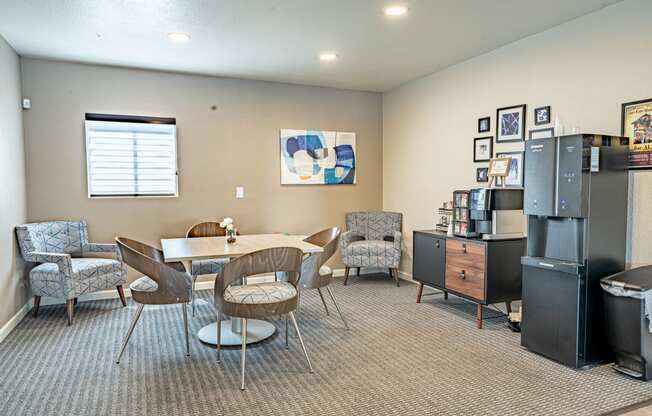 a living room with a table and chairs and a refrigerator