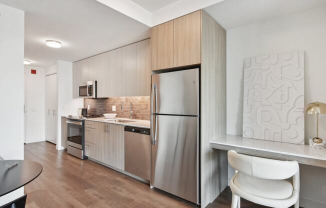 a kitchen with stainless steel appliances and a counter top with a refrigerator at Cassidy on Canal, Chicago, Illinois