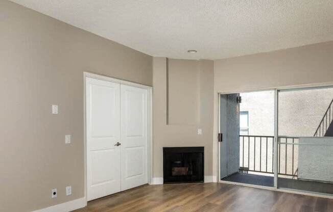 A room with a fireplace and a balcony.
