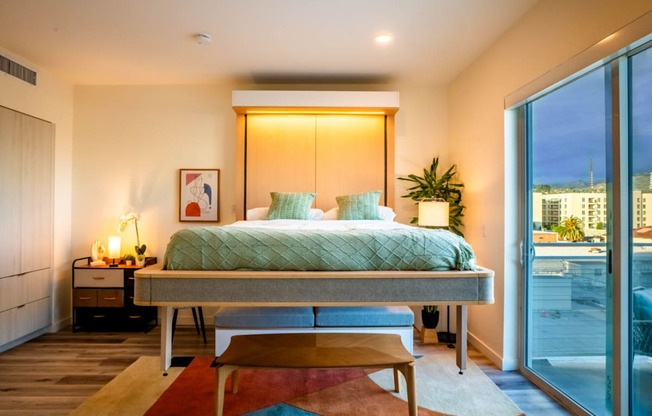 a bedroom with a bed and a sliding glass door