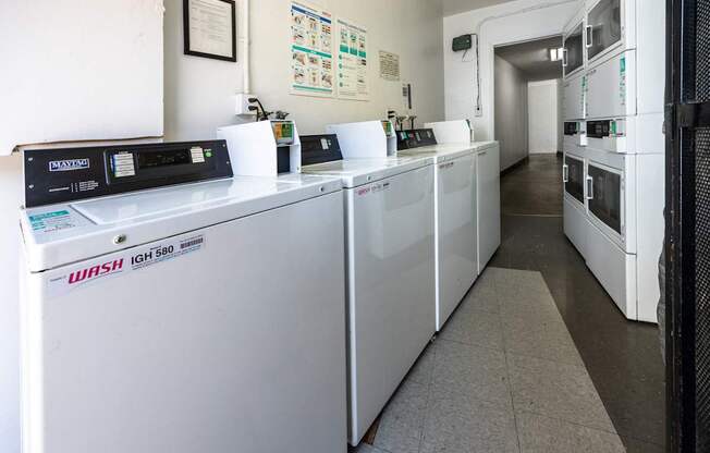 a row of washing machines in a room with a long line ofidges