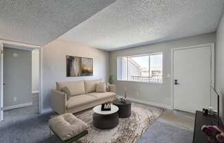 A living room with a couch, a coffee table, and a painting on the wall.